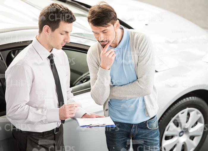 Car Salesman Talking To Client Stock Photo