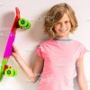Smiling Little Girl Holding Skateboard With Her Right Hand Stock Photo