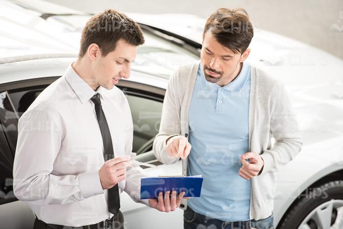 Car Seller Talks With Client Stock Photo