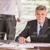 Aged Man Architect Working Behind The Table Stock Photo
