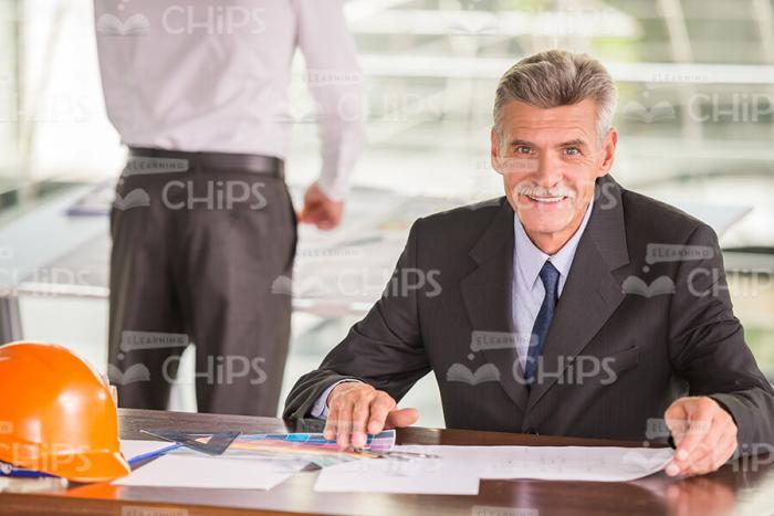 Aged Man Architect Working Behind The Table Stock Photo