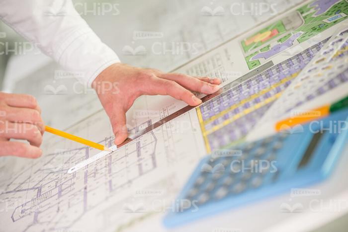 Male Architect's Hands Holding Pencil And Ruler Stock Photo
