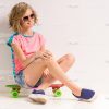 Young Girl Sitting On Skateboard Stock Photo