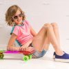 Nice Girl Sitting On Floor With Her Skateboard Stock Photo