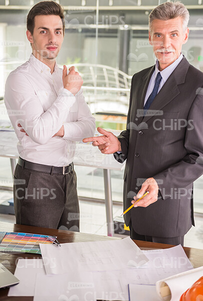 Two Handsome Architects Discussing Their Businesses Stock Photo