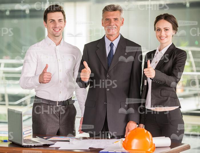 Team Of Architects SHowing Their Thumbs Up Stock Photo