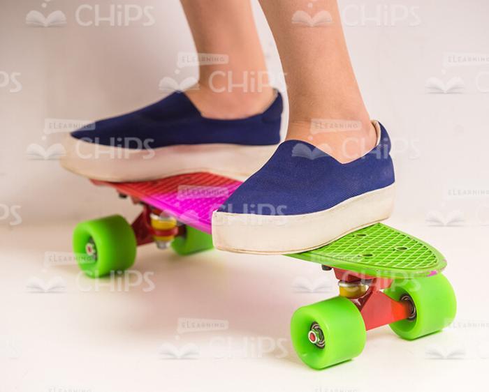 Little Girl's Legs On Skateboard Stock Photo