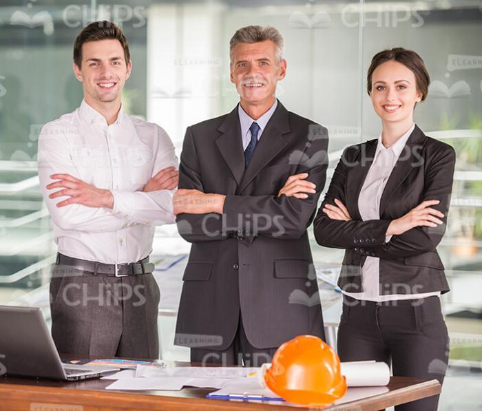 Three Presentable Architects With Crossed Arms Stock Photo