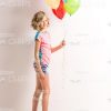 Little Girl On Skateboard Holding Balloons Stock Photo