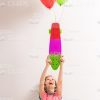 Little Girl Raising Up Skateboard With Balloons Stock Photo