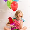 Happy Little Girl With Skateboard And Balloons Holding Lollipop Stock Photo
