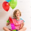 Cute Little Girl With Skateboard, Balloons And Lollipop Stock Photo