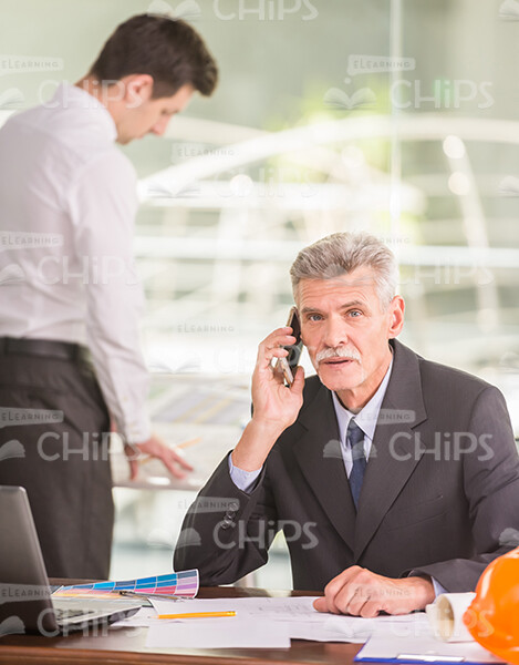 Aged Man Engineer Talking The Mobile Phone Stock Photo