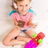 Pretty Young Girl With Skateboard And Chocolate Listening Music In Headphones Stock Photo