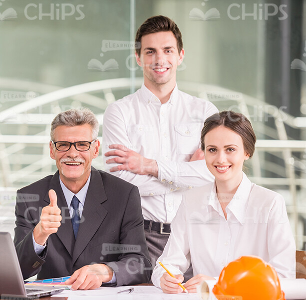 Two Young Engineers And Their Happy Chief Showing Thumb Up Stock Photo