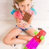 Top View On Smiling Girl In Headphones Eating Chocolate Stock Photo