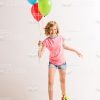 Happy Little Girl In Rollers Holding Balloons Stock Photo