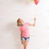 Nice Little Girl Wearing Rollers And Holding Colorful Balloons Stock Photo