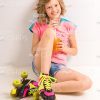 Smiling Girl In Rollers Sitting On Floor And Drinking Juice Stock Photo