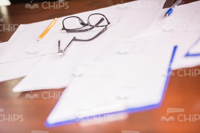Glasses And Business Papers On The Table Stock Photo
