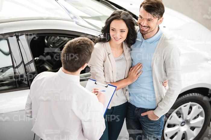 Couple Listens To Car Consultant Stock Photo