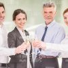 Business Team Clincking Glasses While Celebrating Stock Photo