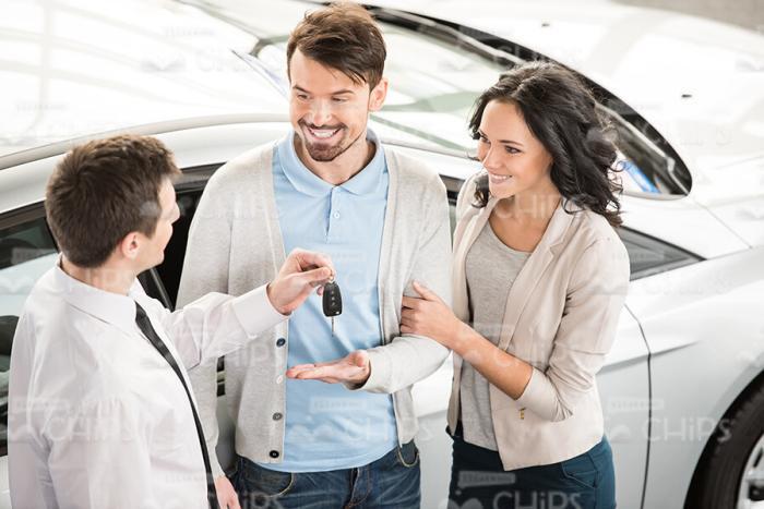 Salesman Talking With Couple Of Clients Stock Photo