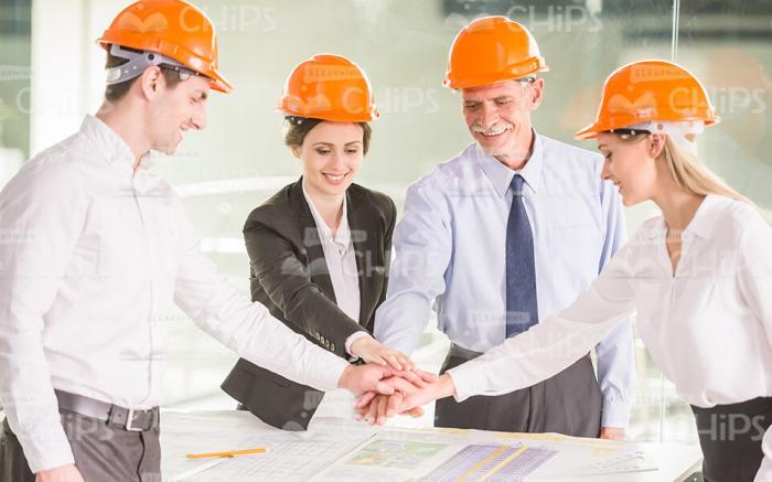 Friendly Team of Architects Putting Hand On Hand Together Stock Photo