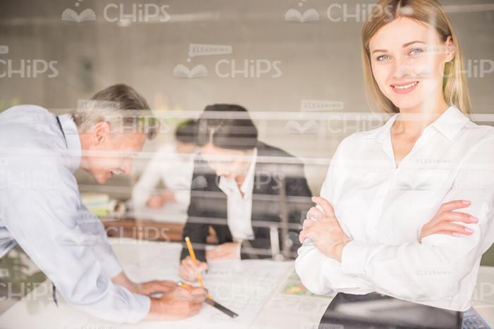 Smiling Business Woman Crosses Her Arms Stock Photo