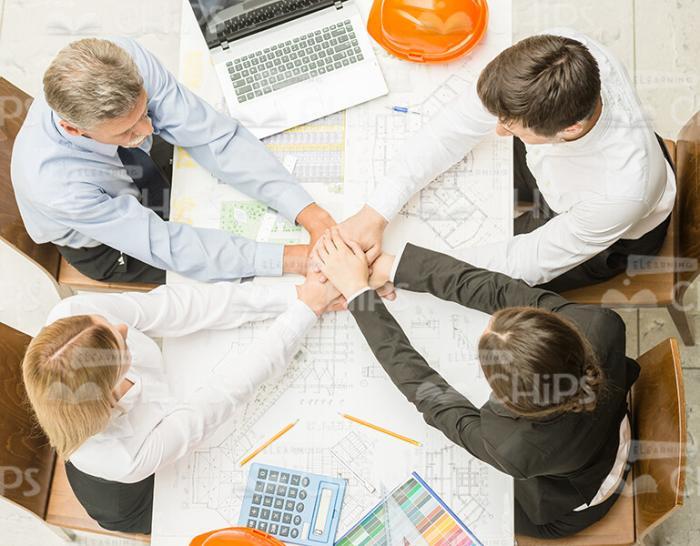 Friendly Engineers Making Hand On Hand Gesture View From Above Stock Photo