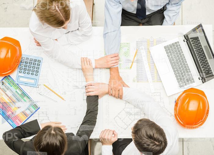 Four Architects Crosses Hands Together Stock Photo