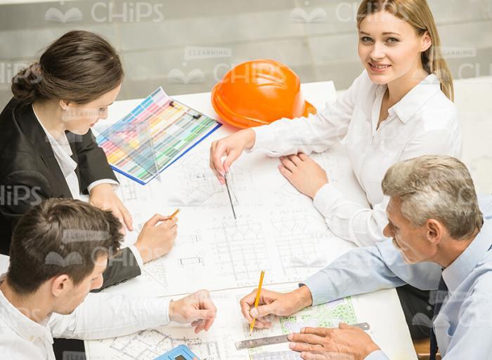Four Engineers Making Drawings Stock Photo