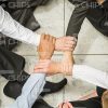 Four Hands Crossed Together View From Above Stock Photo