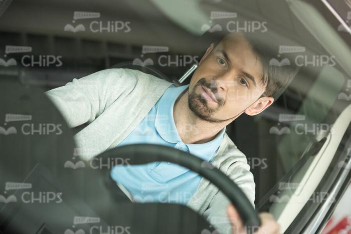 Man Sits In Driver's Seat Stock Photo