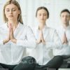 Business People Relaxing And Meditating Stock Photo