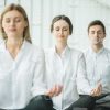 Three Young Business People Resting After Hard Working Day Stock Photo
