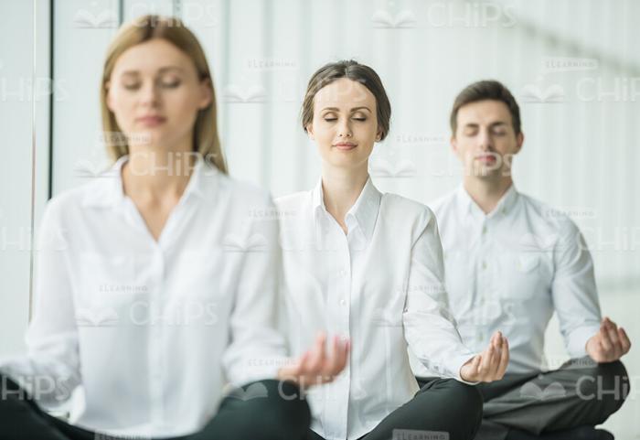 Three Young Business People Resting After Hard Working Day Stock Photo