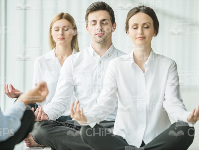 Group Of Young People Resting After Working Day Stock Photo