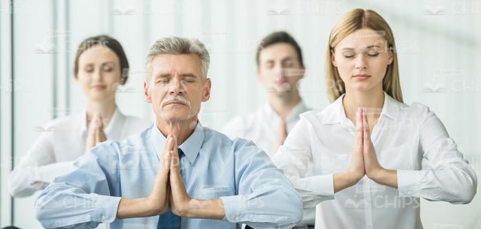 Business People Relaxing And Meditating Stock Photo