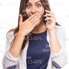 Open-Eyed Young Lady Talking On Phone And Covering Mouth Stock Photo White Background