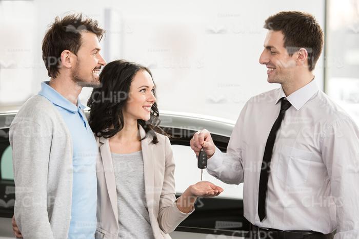 Couple Talking With Car Seller Stock Photo