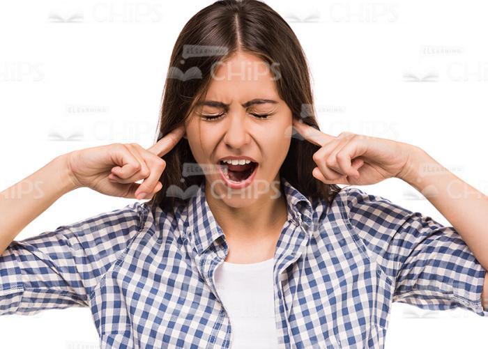 Young Woman Screams And Covers Both Ears With Fingers Stock Photo