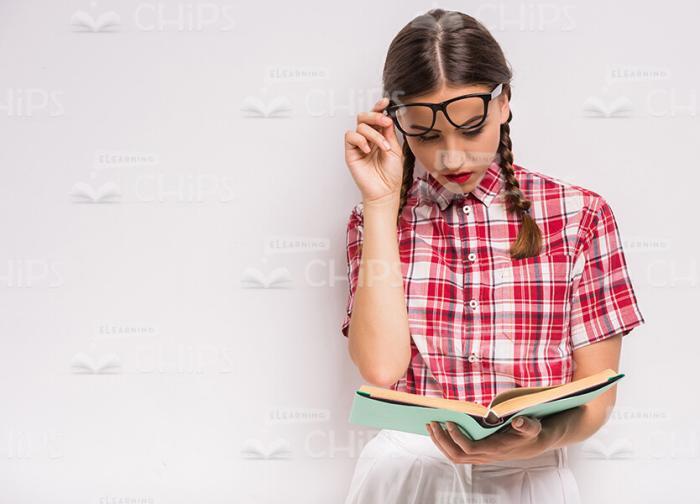 Young Woman Reading Book Stock Photo