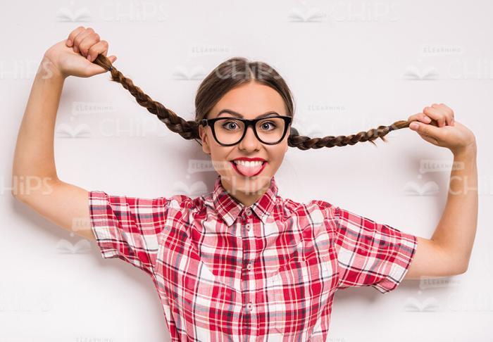 Extremely Happy Young Girl Throwing Up Pigtails Stock Photo