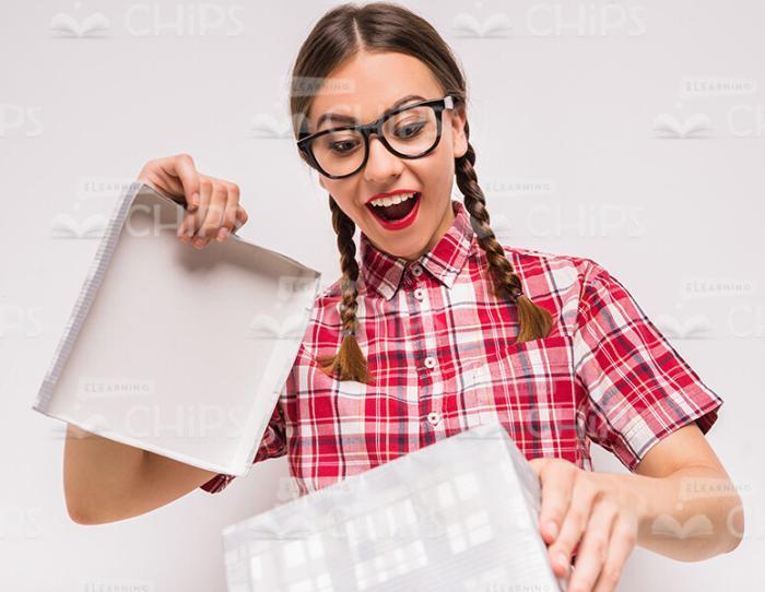 Excited Young Girl Opening The Box Stock Photo
