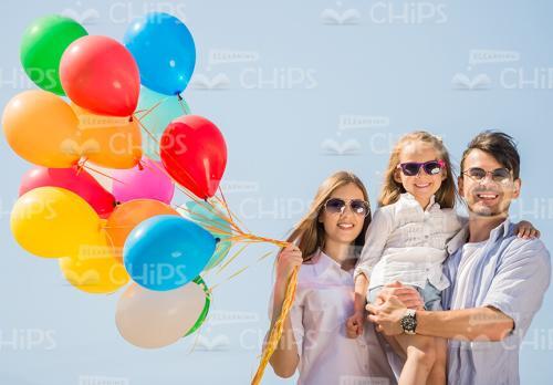 Young Family With Balloons Stock Photo