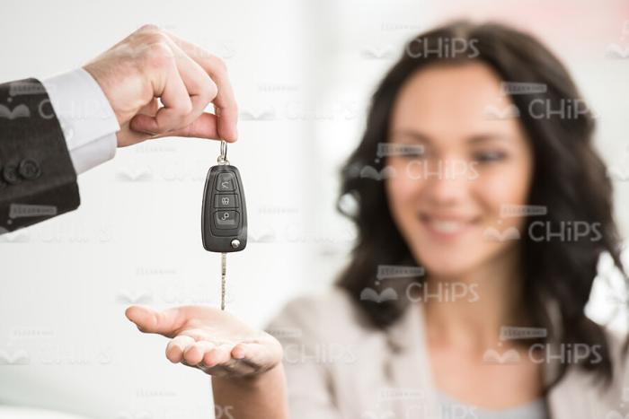 Glad Woman Taking New Car's Key Stock Photo