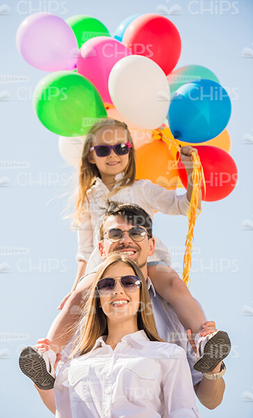 Nice Young Family With With Balloons