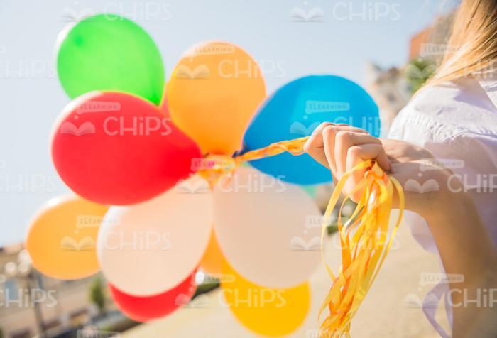 Hand Holding Bunch On Balloons Stock Photo