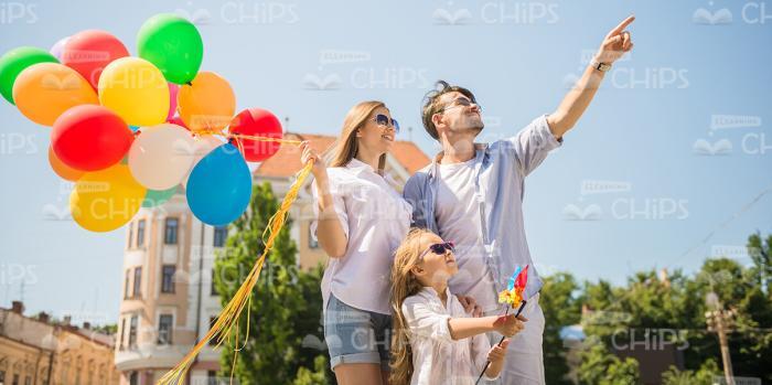Cheerful Family With Bunch Of Balloons Stock Photo